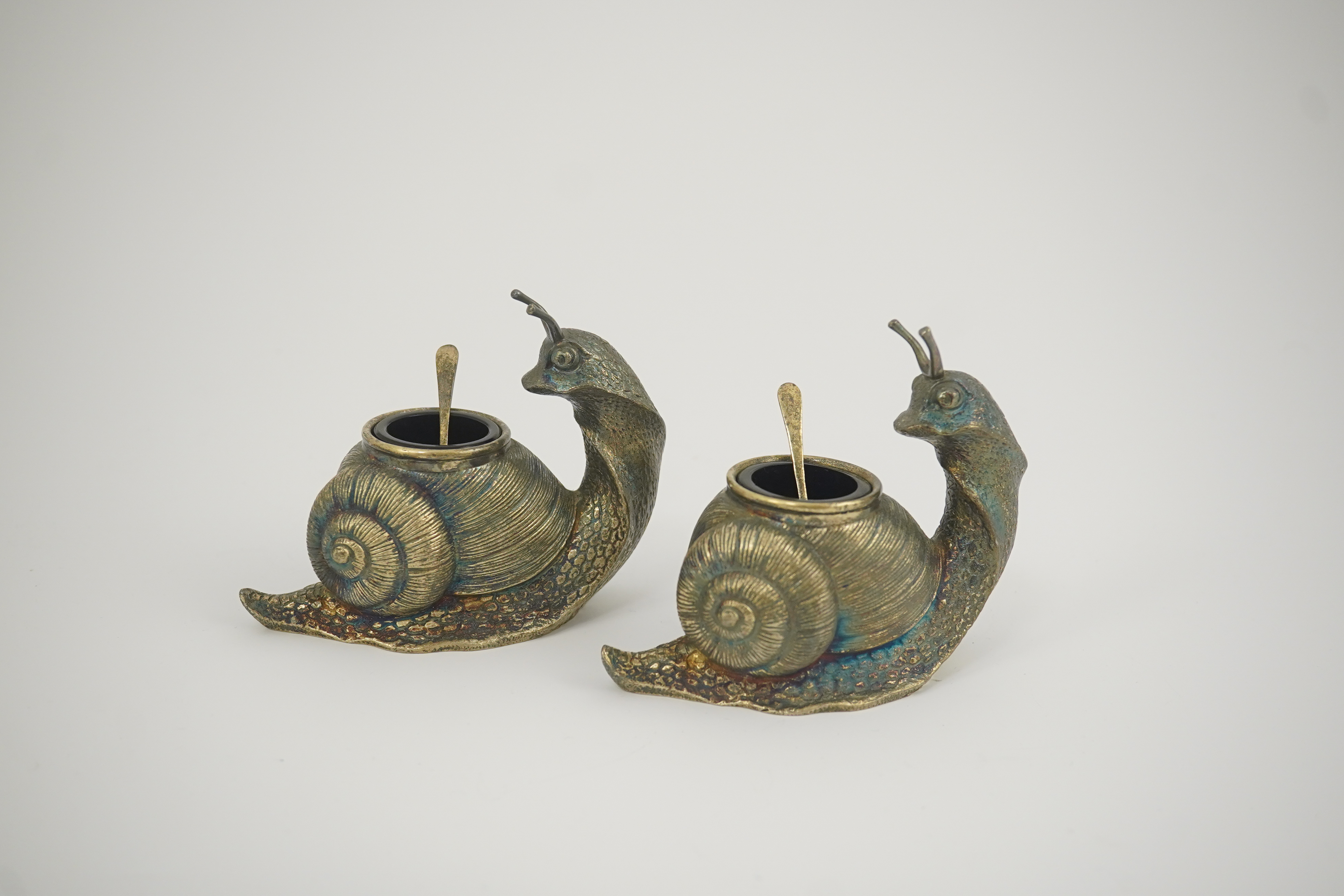 A pair of Elizabeth II novelty cast silver salts and spoons, by Garrard & Co, modelled as snails